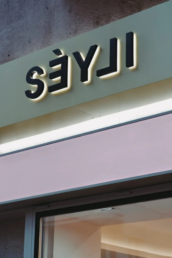 Illuminated SÉYLI storefront sign above the boutique entrance