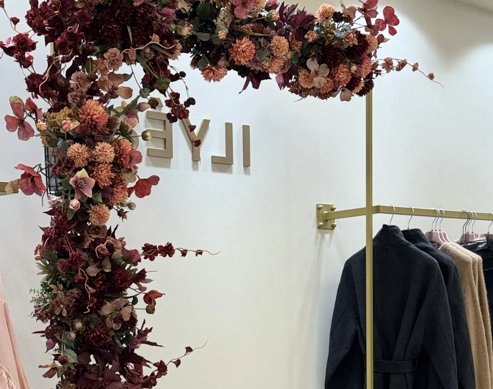 Flower arch and clothing rail inside the Firenze boutique
